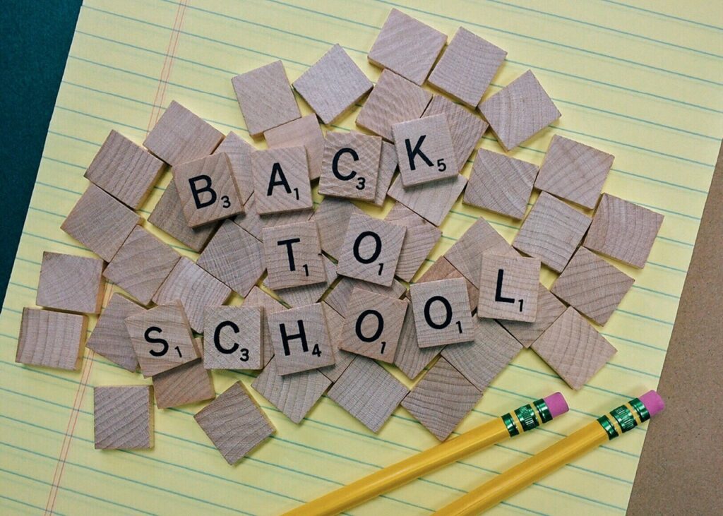 tiles back to school on yellow notebook