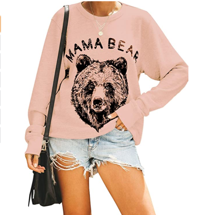 Woman in pink sweatshirt and cutoffs
