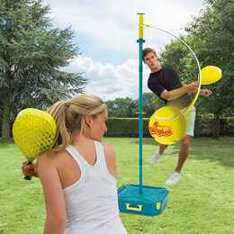 Woman and Man in a garden playing with a portable tennis Set