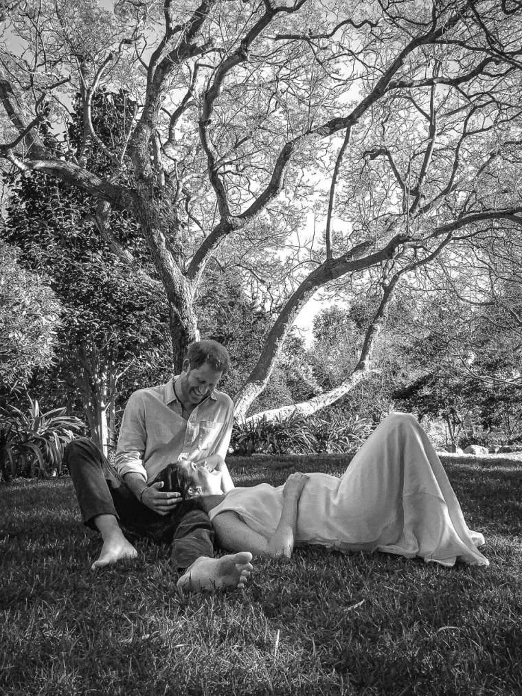 Black and White photo of Meghan Markle and Prince Harry under a tree whillst she was pregnant with her daughter she has since given birth to