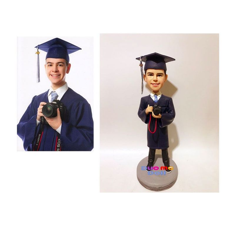 Young Man and a bobblehead of him in graduation gown